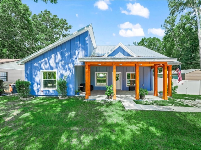 7714 Chase Rd, Lakeland, FL 33810 - back of house featuring board and batten siding and metal roof