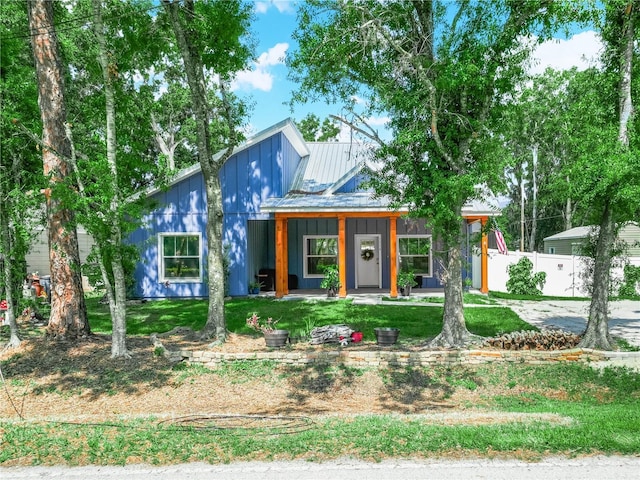 7714 Chase Rd, Lakeland, FL 33810 - view of front of home featuring metal roof, board and batten siding, and covered porch