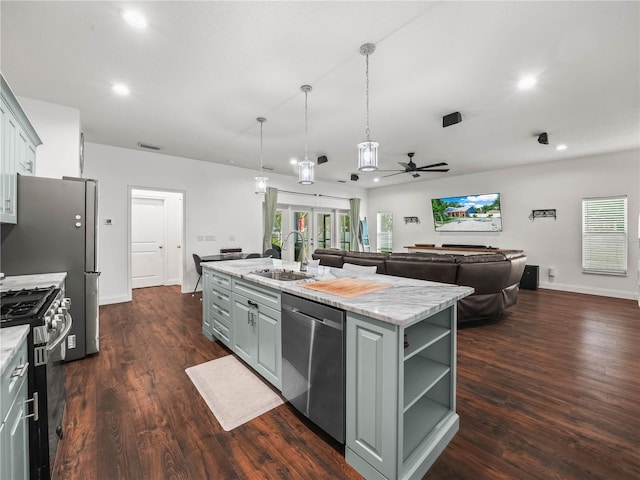 7714 Chase Rd, Lakeland, FL 33810 - kitchen with stainless steel appliances, a sink, gray cabinetry, ceiling fan, and open floor plan