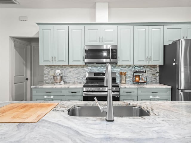 7714 Chase Rd, Lakeland, FL 33810 - kitchen featuring stainless steel appliances, tasteful backsplash, and light stone counters
