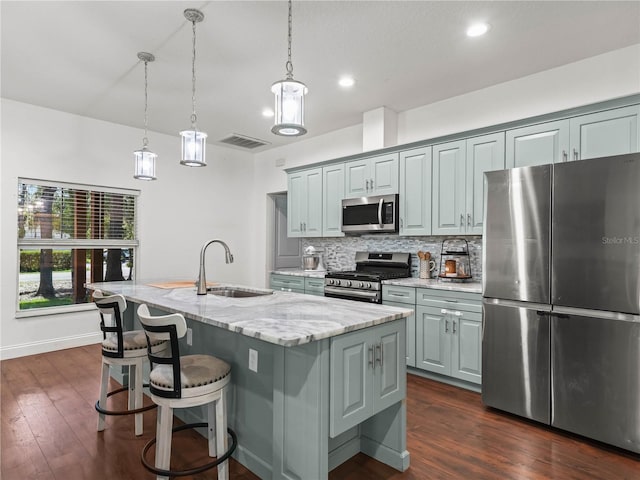 7714 Chase Rd, Lakeland, FL 33810 - kitchen with appliances with stainless steel finishes, a sink, backsplash, light stone counters, and dark wood-style flooring