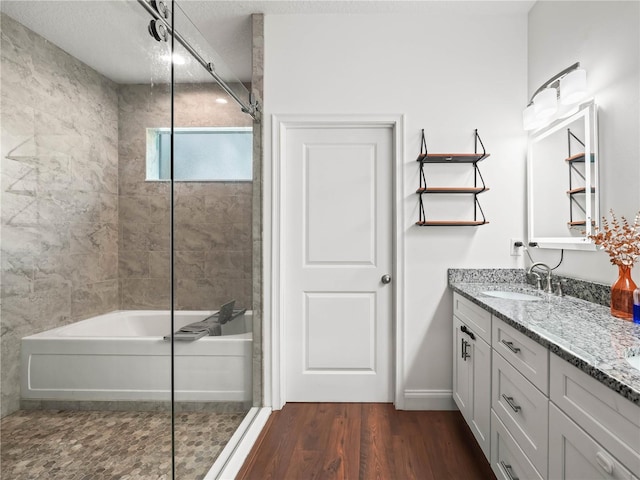 7714 Chase Rd, Lakeland, FL 33810 - bathroom with double vanity, wood finished floors, and  shower combination
