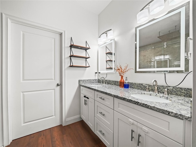 7714 Chase Rd, Lakeland, FL 33810 - bathroom featuring double vanity, wood finished floors, tiled shower, and baseboards