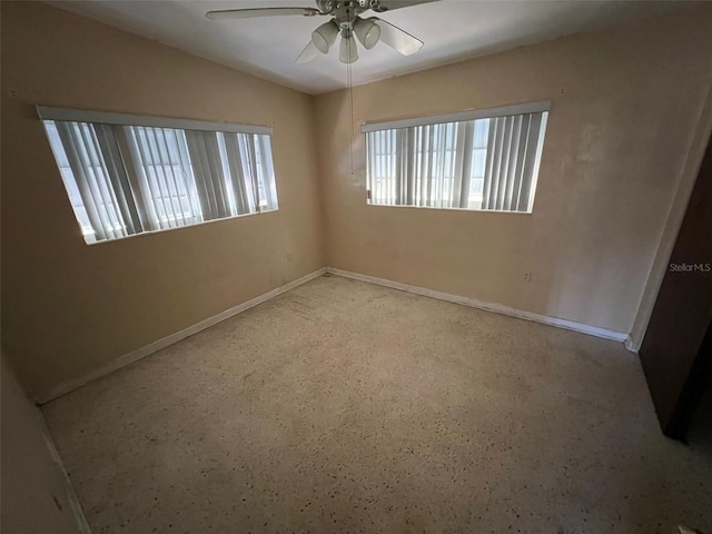 507 Ave H SE, Winter Haven, FL 33880 - spare room with ceiling fan, baseboards, and speckle patterned floor