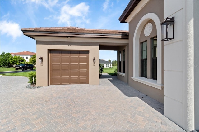209 Pine Lilly Ct, Lake Alfred, FL 33850 - garage featuring decorative driveway