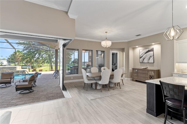 209 Pine Lilly Ct, Lake Alfred, FL 33850 - dining space with ornamental molding, baseboards, and a chandelier