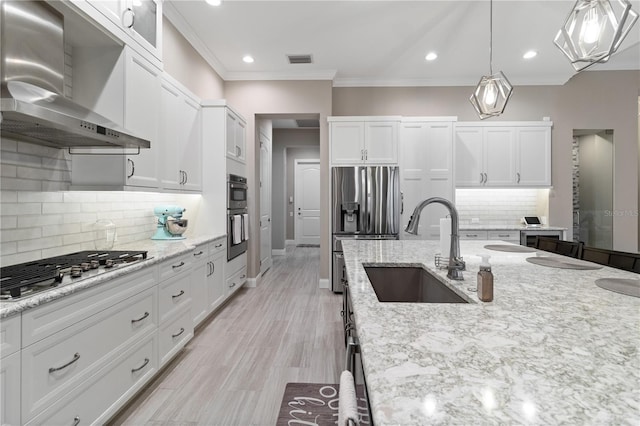 209 Pine Lilly Ct, Lake Alfred, FL 33850 - kitchen featuring wall chimney exhaust hood, a sink, appliances with stainless steel finishes, white cabinets, and tasteful backsplash