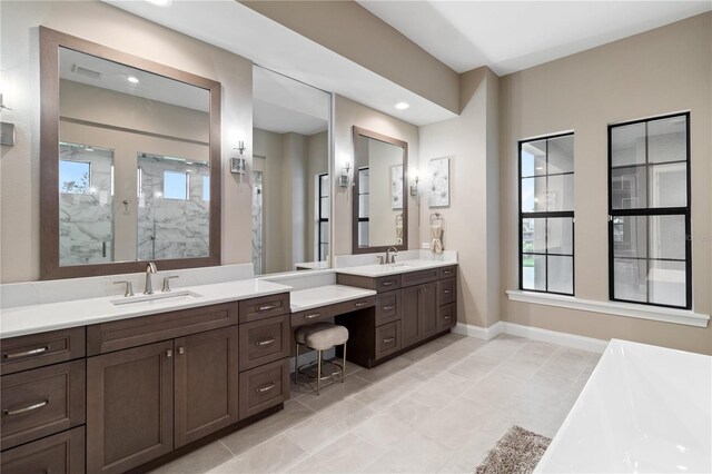 209 Pine Lilly Ct, Lake Alfred, FL 33850 - bathroom featuring a marble finish shower, a freestanding bath, two vanities, baseboards, and recessed lighting