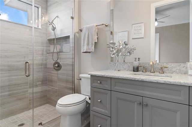 209 Pine Lilly Ct, Lake Alfred, FL 33850 - bathroom with toilet, vanity, a shower stall, and ceiling fan