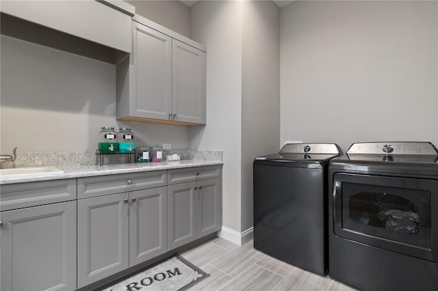 209 Pine Lilly Ct, Lake Alfred, FL 33850 - washroom with washer and dryer, cabinet space, baseboards, and wood tiled floors