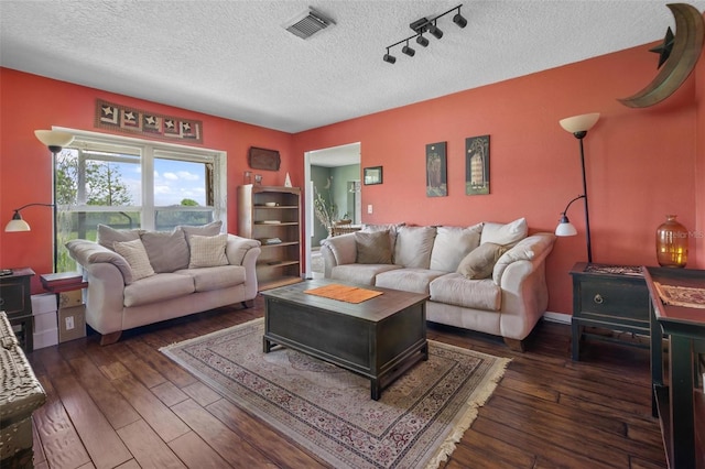 1256 Center St, Dundee, FL 33838 - living area with hardwood / wood-style floors, a textured ceiling, and rail lighting