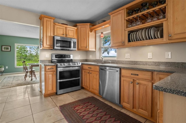 1256 Center St, Dundee, FL 33838 - kitchen featuring appliances with stainless steel finishes, dark countertops, a sink, and plenty of natural light