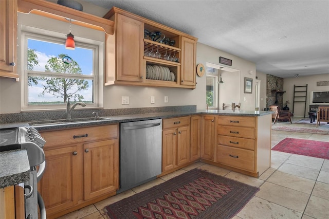1256 Center St, Dundee, FL 33838 - kitchen featuring stainless steel dishwasher, plenty of natural light, open floor plan, a sink, and a textured ceiling