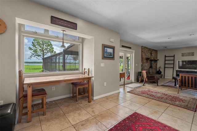 1256 Center St, Dundee, FL 33838 - tiled living room with baseboards, french doors, and a wood stove