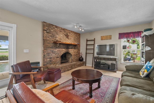 1256 Center St, Dundee, FL 33838 - living room featuring healthy amount of natural light, tile patterned floors, and a brick fireplace