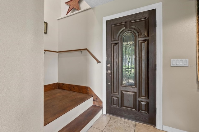 1256 Center St, Dundee, FL 33838 - entrance foyer with stairway and light tile patterned flooring