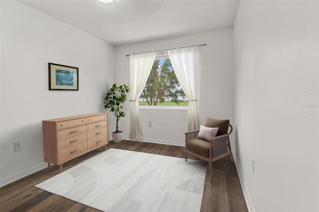 1256 Center St, Dundee, FL 33838 - living area featuring dark wood-style flooring and baseboards