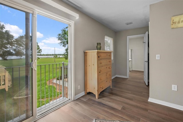 1256 Center St, Dundee, FL 33838 - doorway featuring wood finished floors, baseboards, and a water view