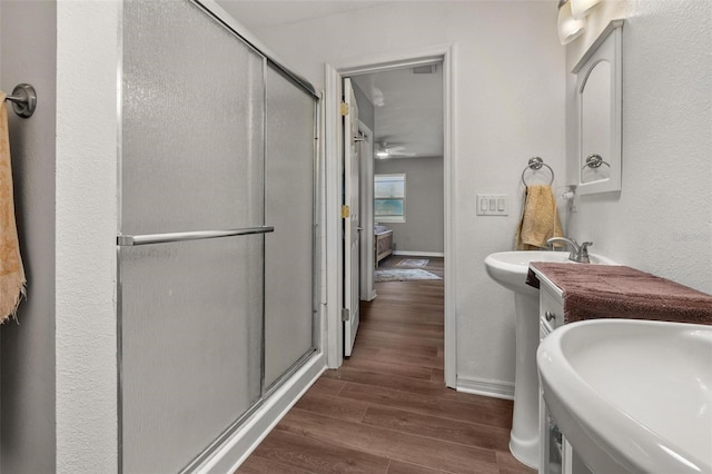 1256 Center St, Dundee, FL 33838 - bathroom featuring a stall shower, wood finished floors, and baseboards