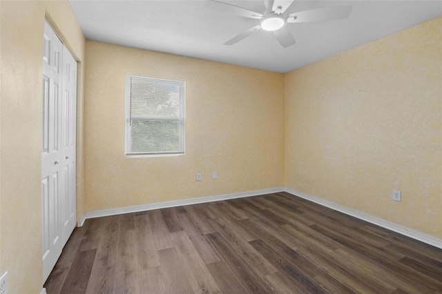 1256 Center St, Dundee, FL 33838 - unfurnished bedroom with dark wood finished floors, a closet, baseboards, and ceiling fan