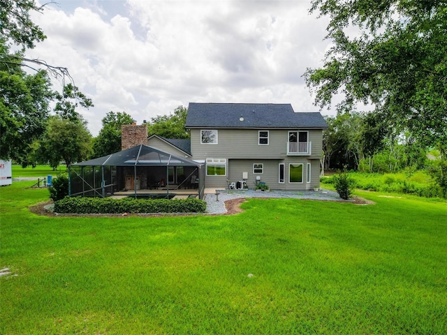 1256 Center St, Dundee, FL 33838 - rear view of house with a patio area, a yard, and glass enclosure
