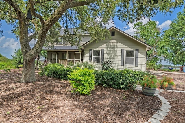 1256 Center St, Dundee, FL 33838 - view of front facade featuring a sunroom