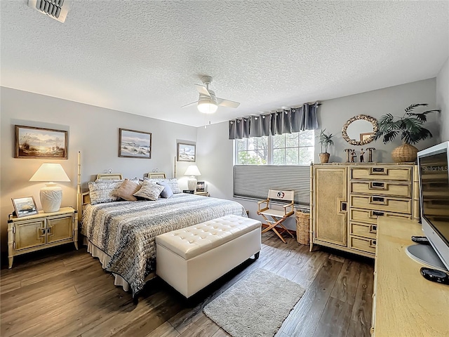 8640 Firestone Cir, Clermont, FL 34711 - bedroom featuring a textured ceiling, dark wood-style flooring, and a ceiling fan