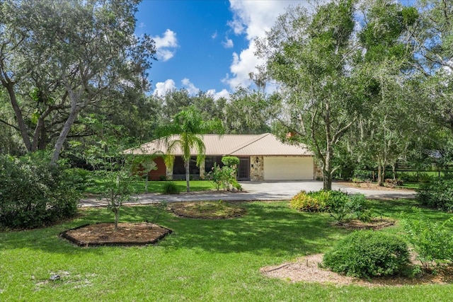 1273 Scrub Jay Trl, Frostproof, FL 33843 - ranch-style house with asphalt driveway, a garage, a front yard, and a metal roof