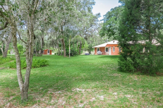 1273 Scrub Jay Trl, Frostproof, FL 33843 - view of green lawn featuring an outdoor structure