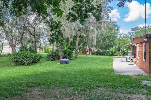 1273 Scrub Jay Trl, Frostproof, FL 33843 - view of grassy yard featuring a patio and an outbuilding