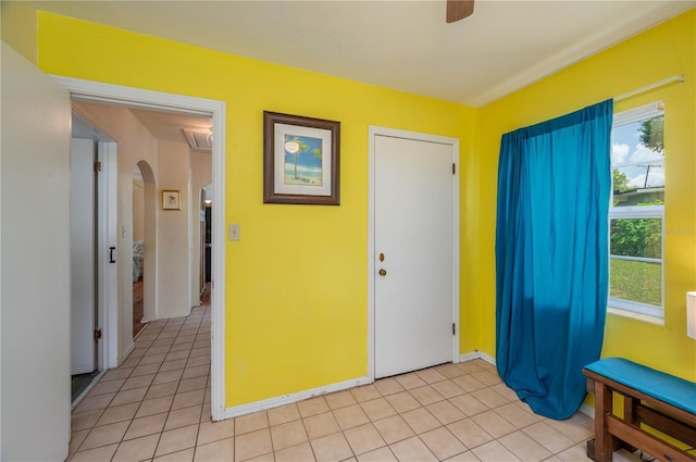 304 W Lake Ave, Auburndale, FL 33823 - foyer with arched walkways, light tile patterned floors, a ceiling fan, and baseboards