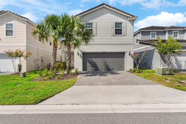 7247 Oakmoss Loop, Davenport, FL 33837 - traditional-style house with an attached garage, driveway, stucco siding, a front lawn, and a tile roof