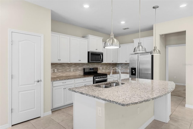 7247 Oakmoss Loop, Davenport, FL 33837 - kitchen featuring appliances with stainless steel finishes, a sink, light tile patterned floors, white cabinets, and recessed lighting