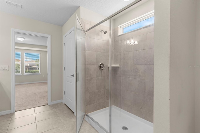 7247 Oakmoss Loop, Davenport, FL 33837 - full bathroom with a shower stall, healthy amount of natural light, tile patterned flooring, and baseboards