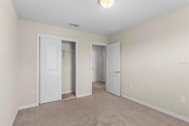 7247 Oakmoss Loop, Davenport, FL 33837 - unfurnished bedroom featuring light carpet, baseboards, and a closet