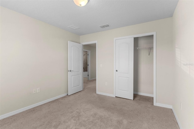 7247 Oakmoss Loop, Davenport, FL 33837 - unfurnished bedroom with carpet, baseboards, a closet, and a textured ceiling