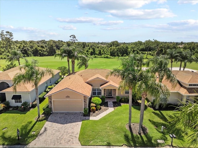 4254 Berwick Dr, Lake Wales, FL 33859 - view of front of home featuring a garage, driveway, a front lawn, and stucco siding
