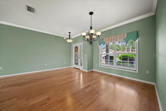 4254 Berwick Dr, Lake Wales, FL 33859 - spare room featuring a chandelier, wood finished floors, and ornamental molding