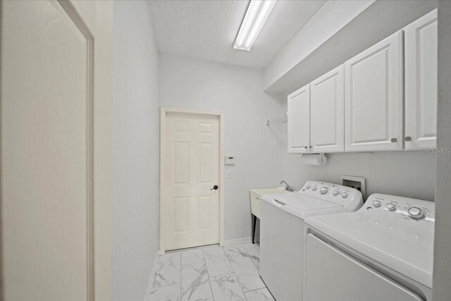 4254 Berwick Dr, Lake Wales, FL 33859 - laundry room with cabinet space, independent washer and dryer, light marble finish floors, and a textured ceiling