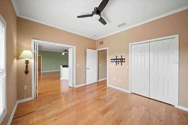 4254 Berwick Dr, Lake Wales, FL 33859 - unfurnished bedroom featuring light wood-style floors, crown molding, a closet, and ceiling fan