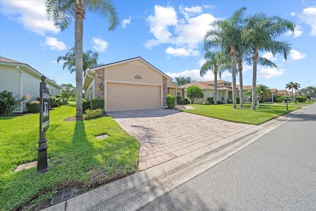 4254 Berwick Dr, Lake Wales, FL 33859 - view of front of home with decorative driveway, an attached garage, a front yard, a residential view, and stucco siding