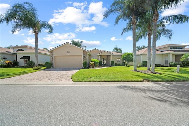 4254 Berwick Dr, Lake Wales, FL 33859 - view of front of property with decorative driveway, an attached garage, a front lawn, and stucco siding