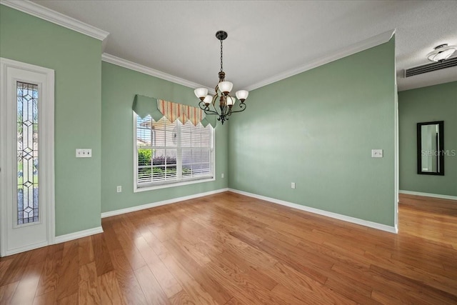 4254 Berwick Dr, Lake Wales, FL 33859 - empty room featuring plenty of natural light, a chandelier, wood finished floors, and crown molding