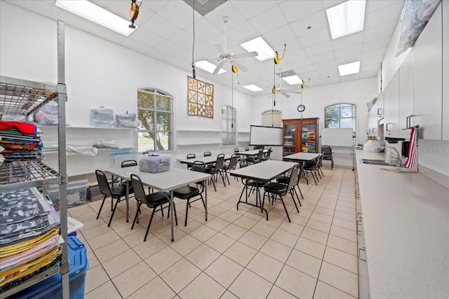 4254 Berwick Dr, Lake Wales, FL 33859 - dining area with a skylight, a drop ceiling, light tile patterned flooring, a ceiling fan, and a towering ceiling