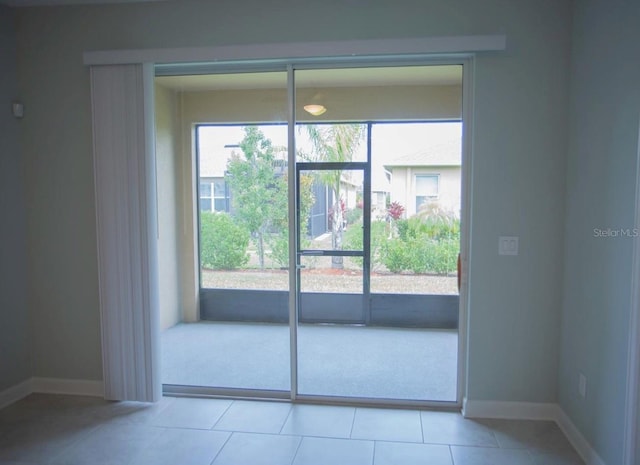 3023 Caneel, Winter Haven, FL 33884 - doorway to outside with baseboards and light tile patterned flooring