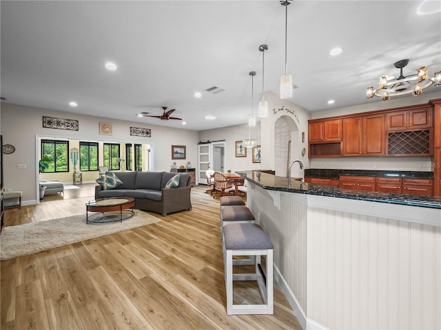 3802 Litchfield Loop, Lake Wales, FL 33859 - kitchen featuring open floor plan, a kitchen bar, recessed lighting, a chandelier, and light wood-style floors