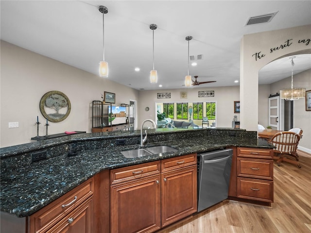 3802 Litchfield Loop, Lake Wales, FL 33859 - kitchen featuring dishwasher, light wood-style floors, brown cabinetry, a chandelier, and pendant lighting