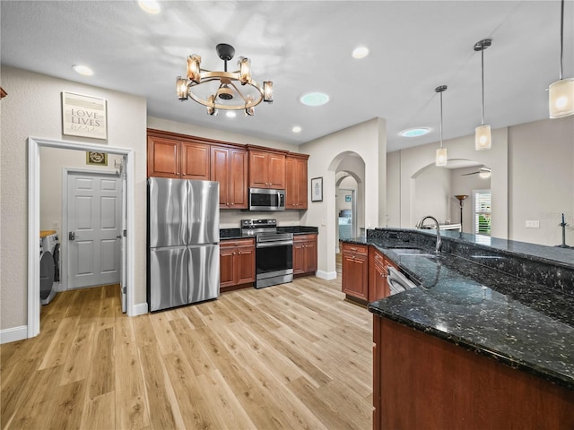3802 Litchfield Loop, Lake Wales, FL 33859 - kitchen featuring stainless steel appliances, arched walkways, light wood-style floors, pendant lighting, and recessed lighting