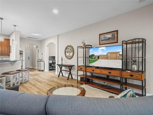 3802 Litchfield Loop, Lake Wales, FL 33859 - living room with arched walkways and light wood finished floors