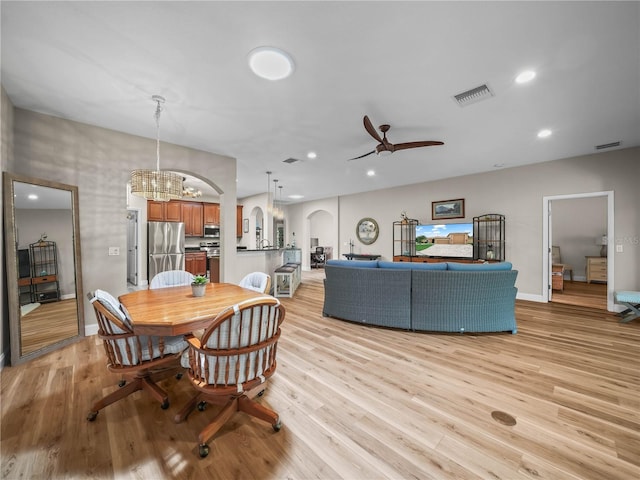 3802 Litchfield Loop, Lake Wales, FL 33859 - dining area with ceiling fan, a chandelier, arched walkways, light wood-type flooring, and recessed lighting